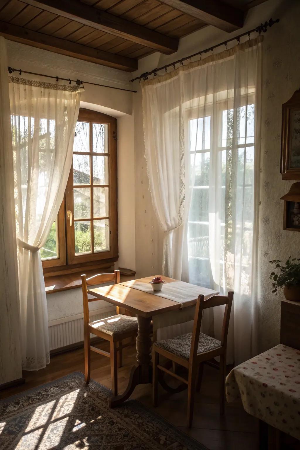 Sheer curtains create a light and airy feel in a small dining room.