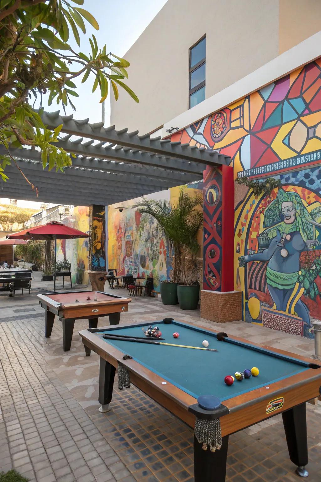 An artistic outdoor billiards area adorned with murals and sculptures.