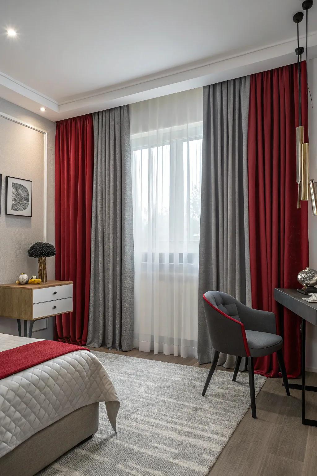 Layered red and grey curtains in a small bedroom add elegance and light control.