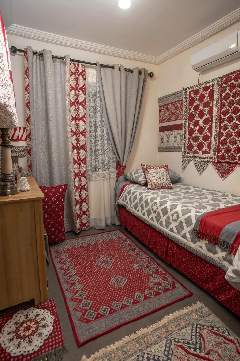 A small bedroom with mixed patterns in textiles adding interest to the red and grey scheme.