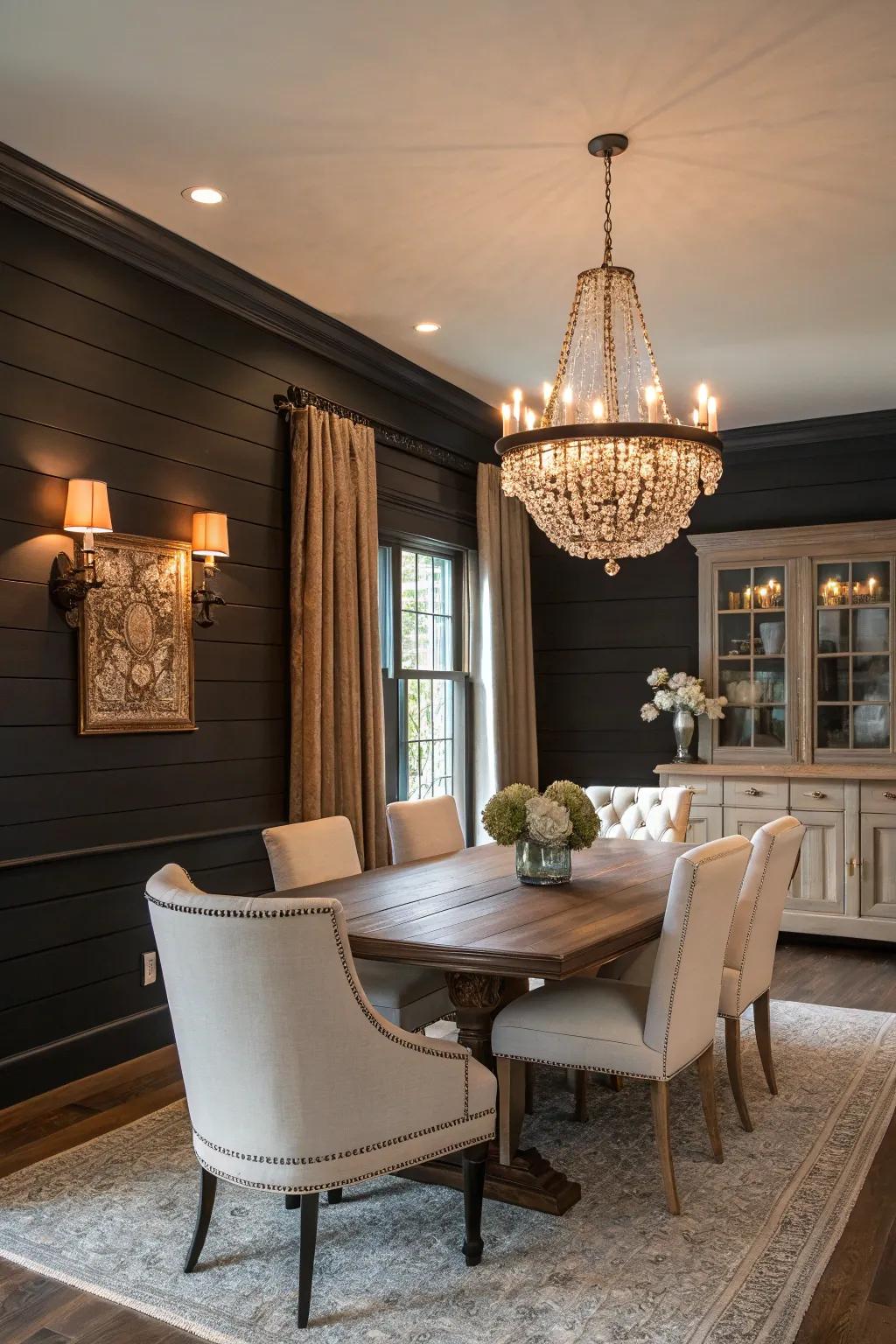 A dining room with dramatic dark shiplap walls and contrasting light furniture.