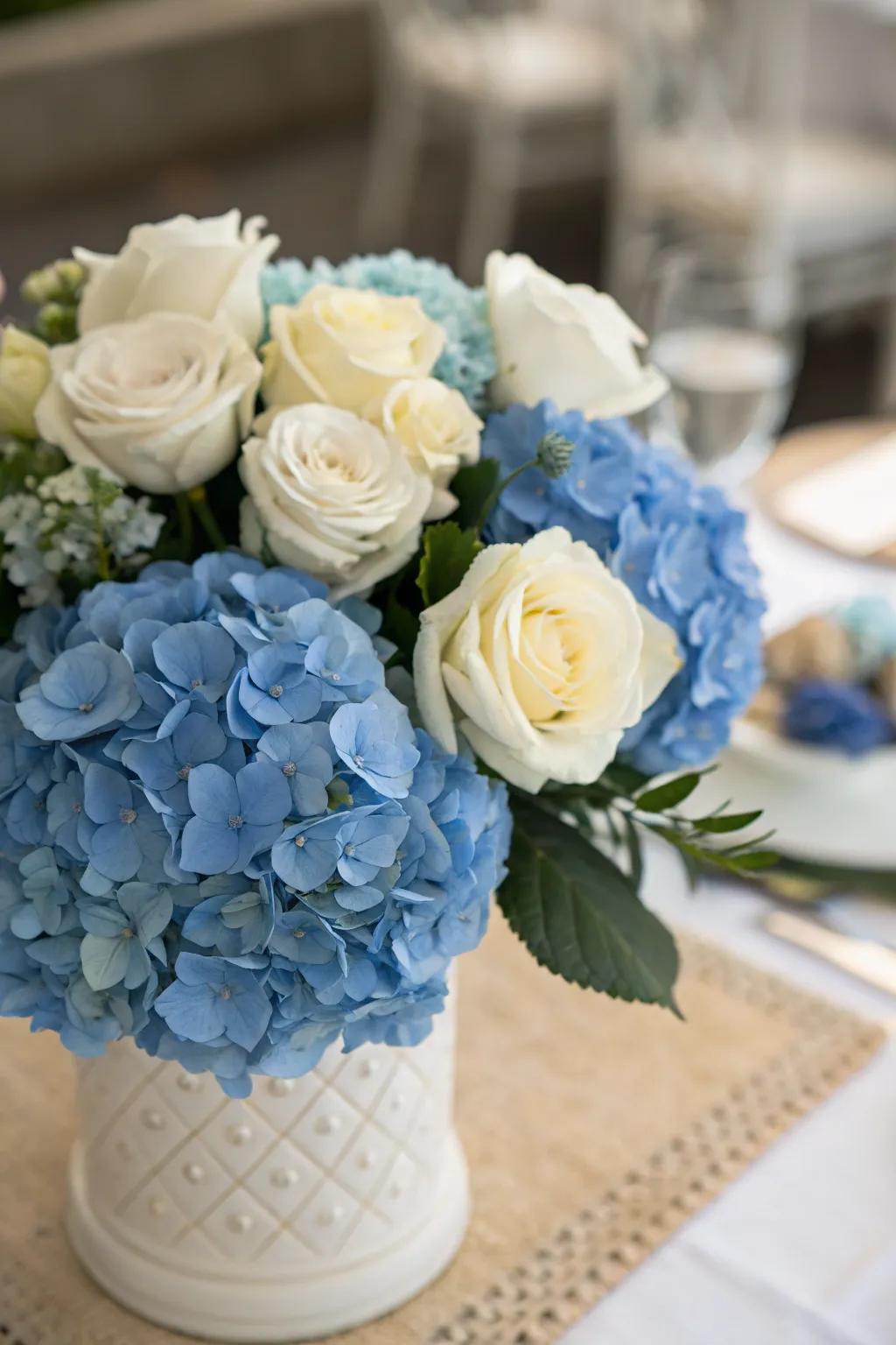 Azure hydrangeas combined with alabaster roses emanate an enduring elegance.