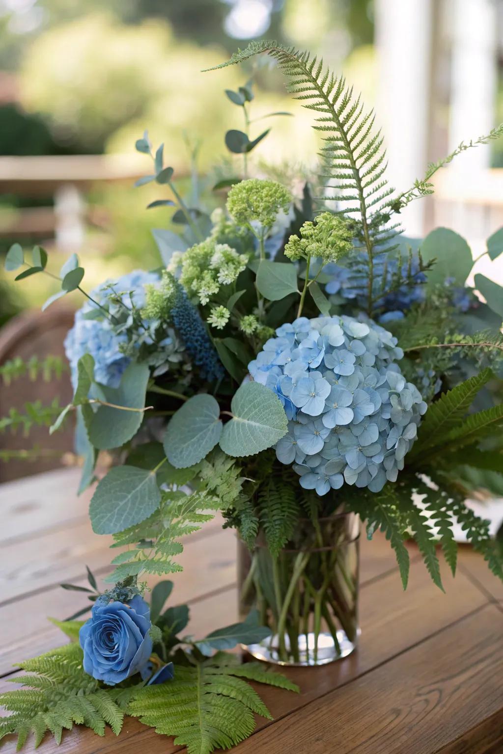 Greenery interlaced with azure hydrangeas yields a full, layered result.