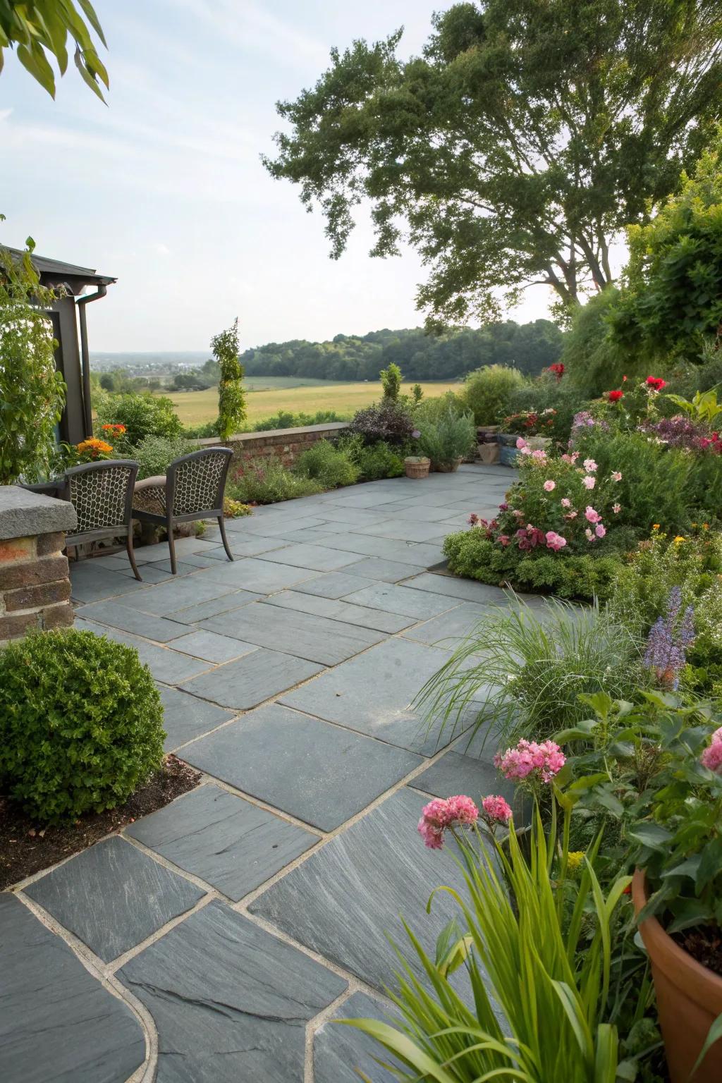 A slate patio exquisitely interwoven with flourishing landscaping.
