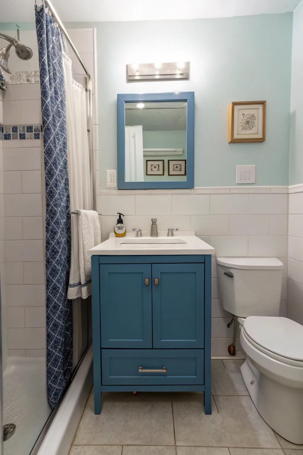 A modern blue vanity stands out as a centerpiece in this chic bathroom.