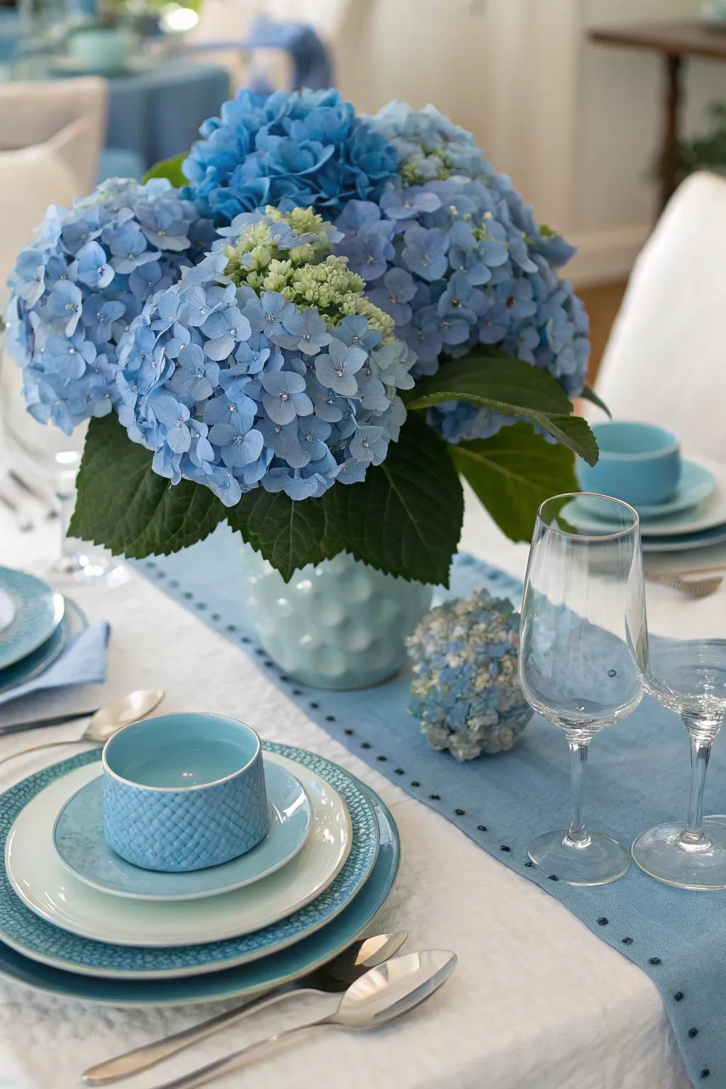 A thematic table arrangement featuring azure highlights complements the hydrangeas.