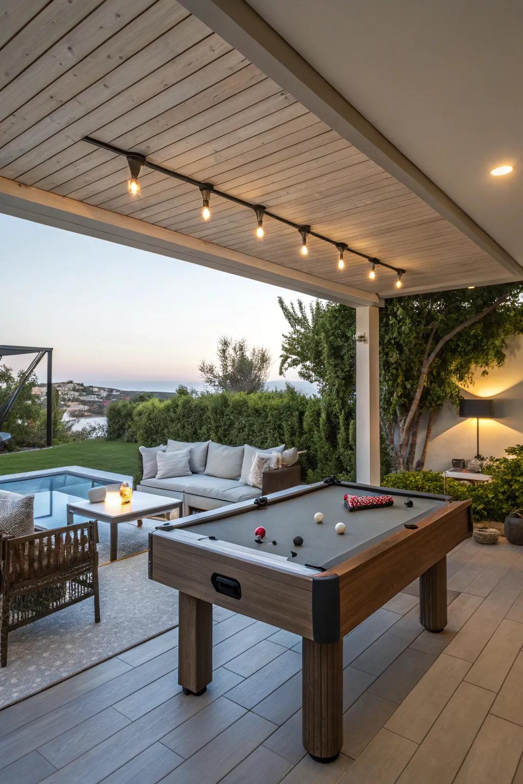 A multi-functional outdoor area featuring a billiards table and comfortable seating.