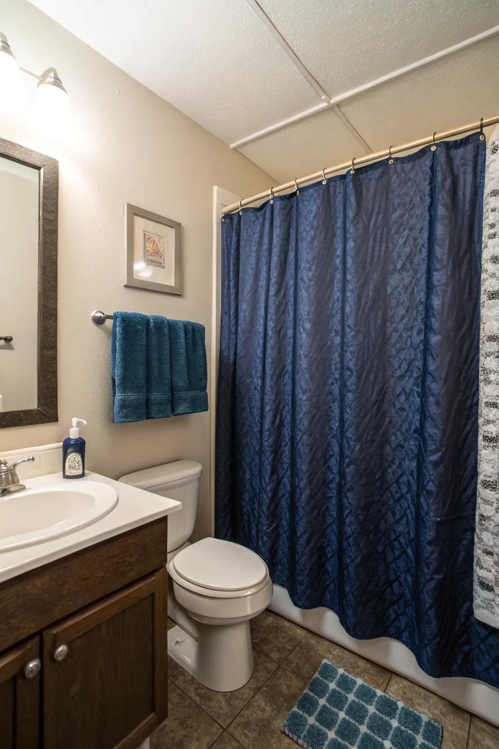 Dark blue shower curtains add a bold statement to this compact bathroom.