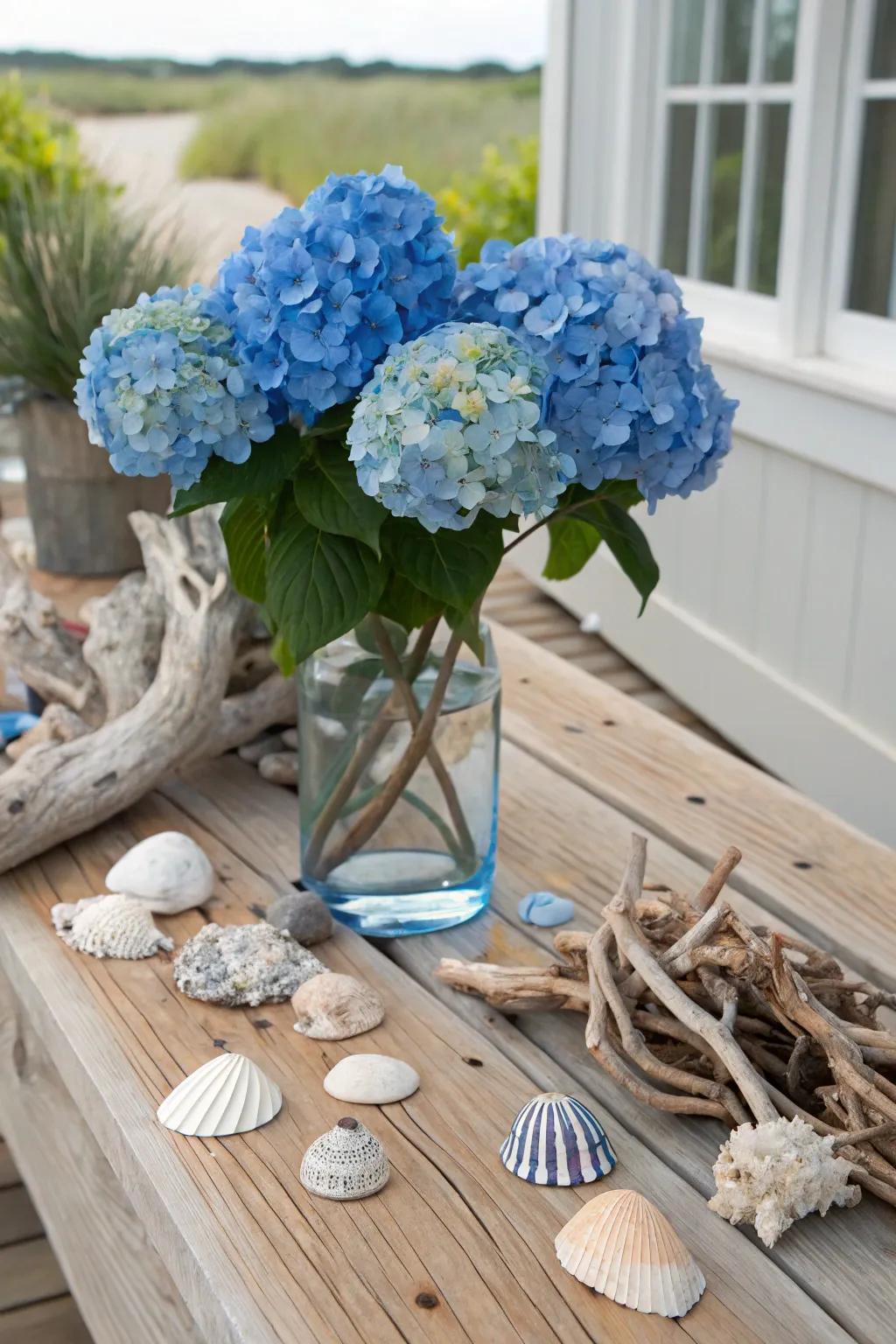 A seaside-inspired centerpiece blending azure hydrangeas alongside seashells.