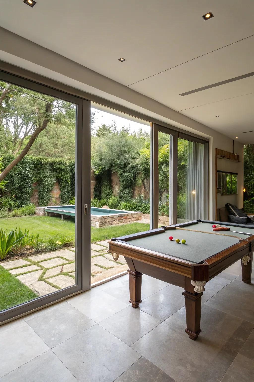 An indoor-outdoor living space featuring a billiards table and garden access.