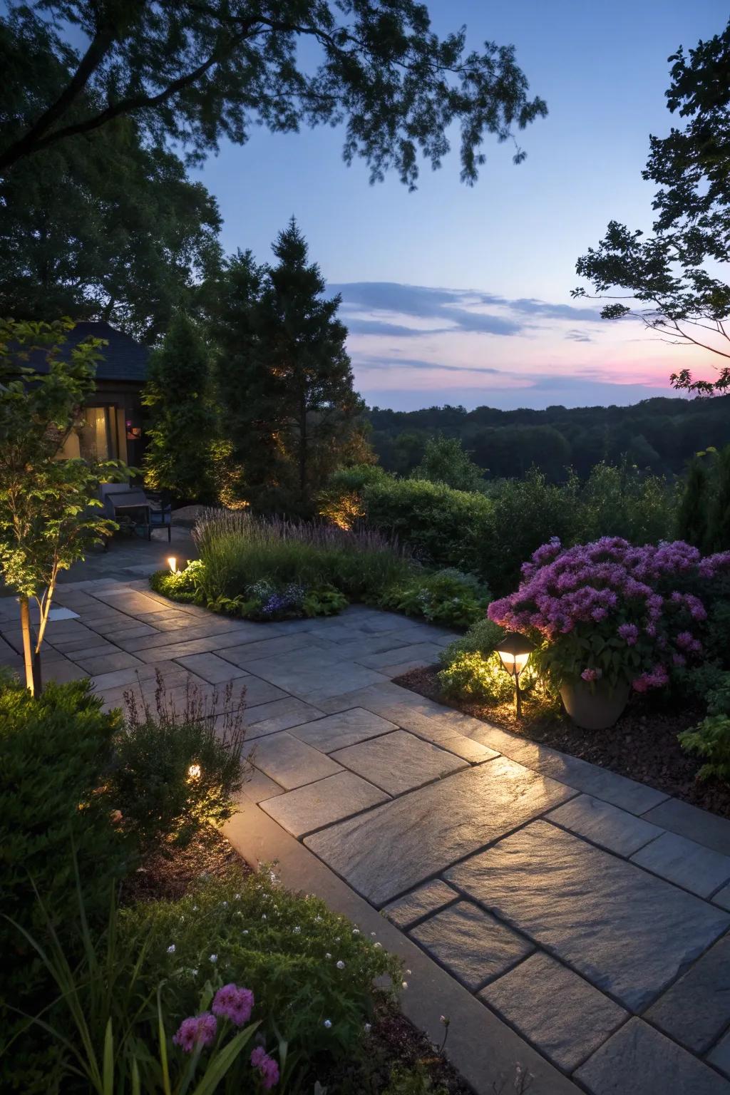 A slate patio beautifully lit with garden illumination.